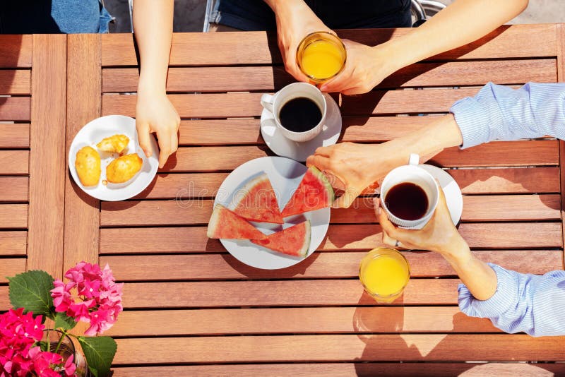 Group of people having breakfast together outdoors stock photo Group of people having breakfast together outdoors stock photo