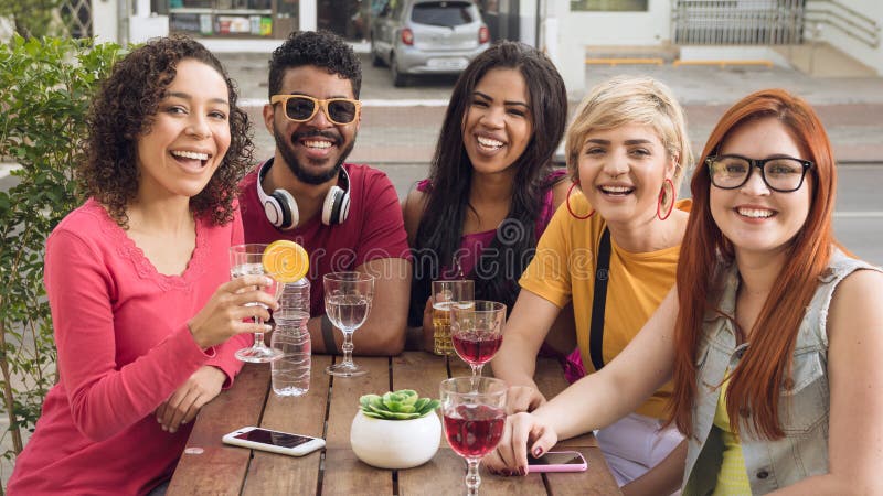 Group of people socializing in a party at restaurant outside.