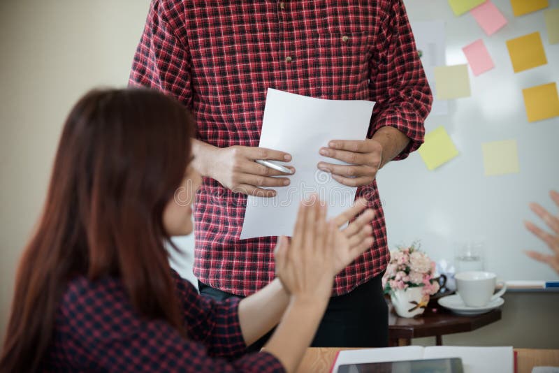 A group of people working in the plaid shirt clap happy after finishing a meeting about the business to be successful.. royalty free stock photo A group of people working in the plaid shirt clap happy after finishing a meeting about the business to be successful.. royalty free stock photo