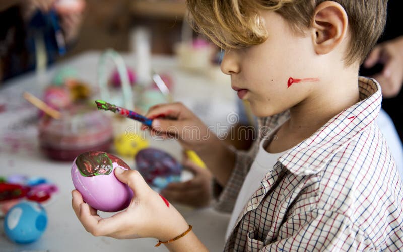 A group of primary schoolers colouring easter eggs