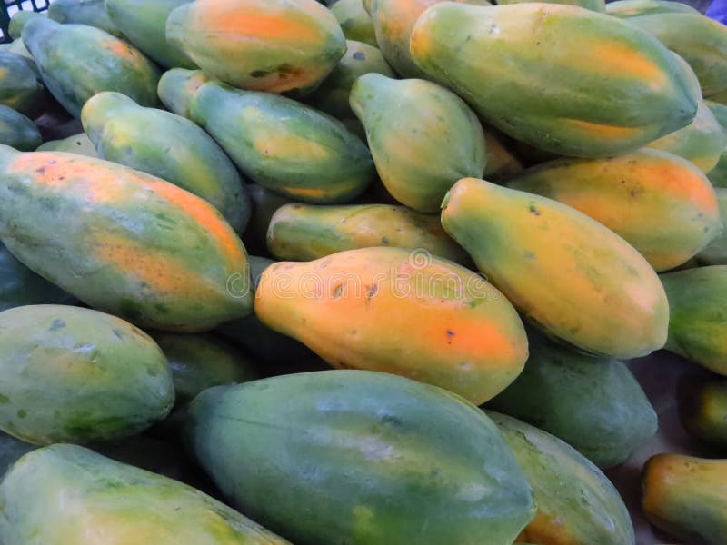 Group of Ripe Orange Green Papayas at a Fruit Market Stock Photo