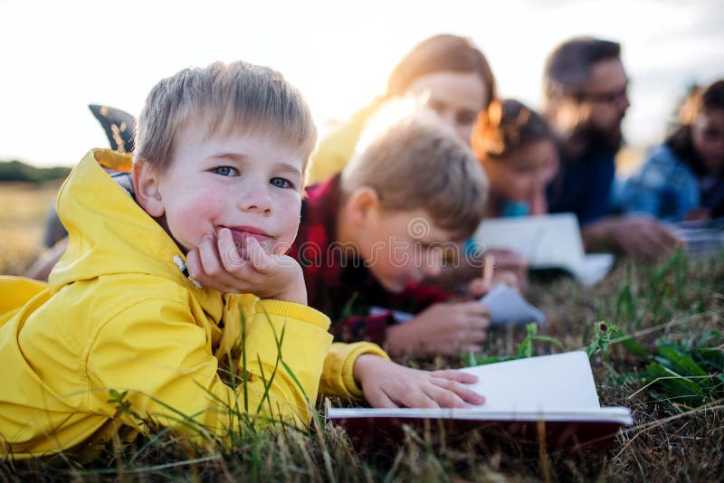 Group of school children with teacher on field trip in nature.