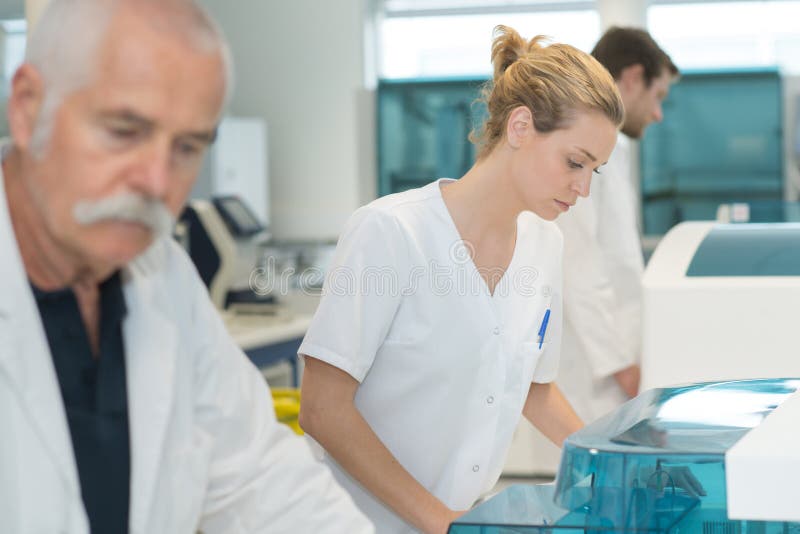 Group scientists studying new substances in flasks royalty free stock photography