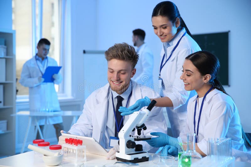 Group of scientists working in chemistry laboratory stock photography