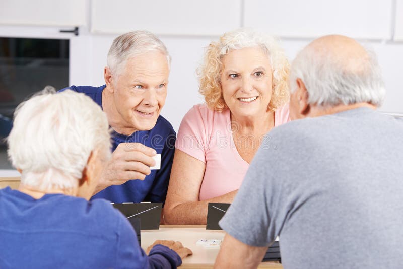 Group of senior people playing rummikub game stock photos Group of senior people playing rummikub game stock photos