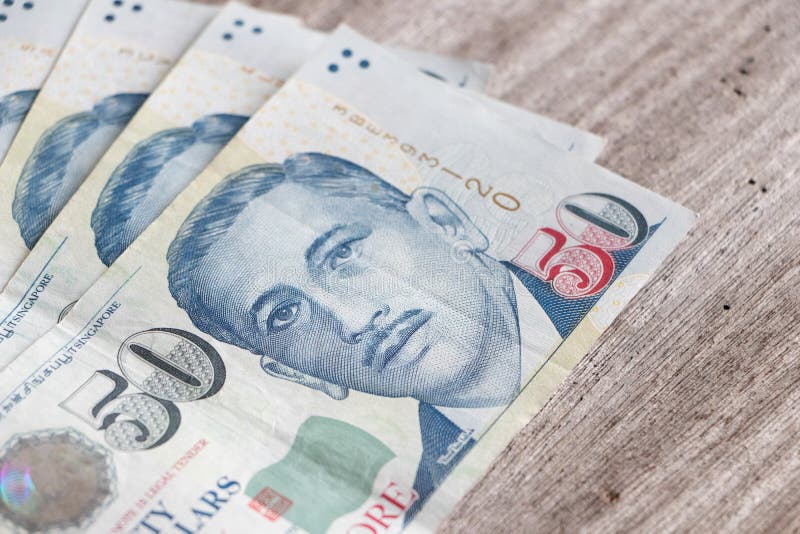 Group of singapore dollar banknote on wooden table.Sungapore currency exchange rate.Saveing and making money concept royalty free stock photo Group of singapore dollar banknote on wooden table.Sungapore currency exchange rate.Saveing and making money concept royalty free stock photo