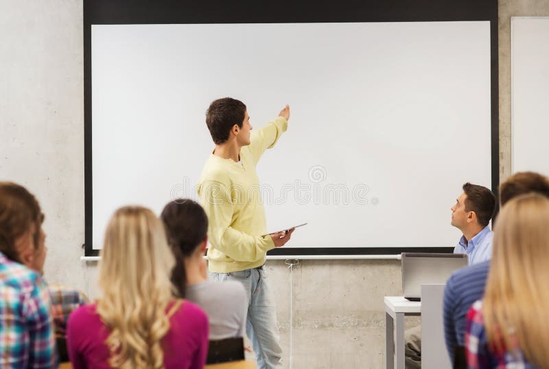 Group of smiling students and teacher in classroom royalty free stock images Group of smiling students and teacher in classroom royalty free stock images