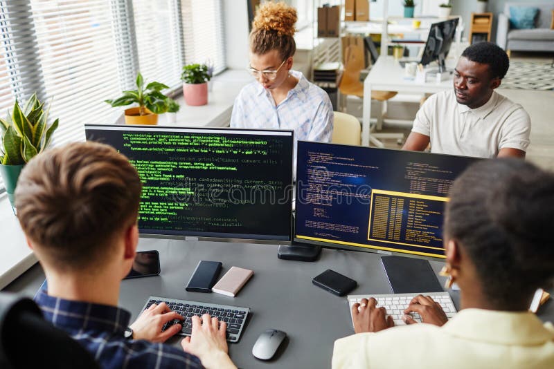 Software developers working with computers at office stock photography