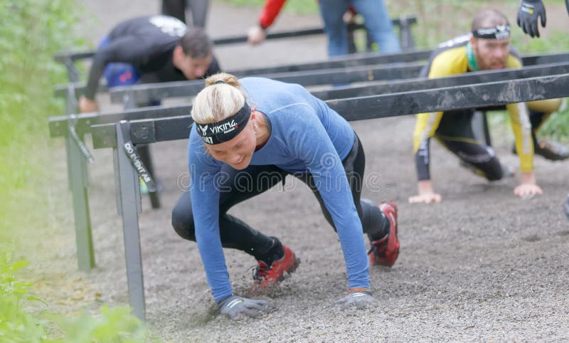 Group of struggling people crawling under bars stock photography Group of struggling people crawling under bars stock photography