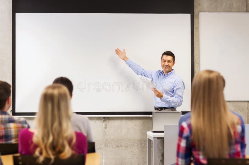 Group of students and smiling teacher with notepad royalty free stock image