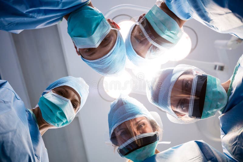 Group Of Surgeons Looking At Camera In Operation Room Stock Photo ...