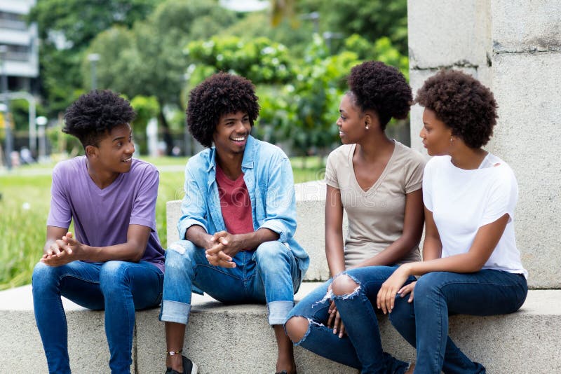 Group of talking african american young adults hanging out