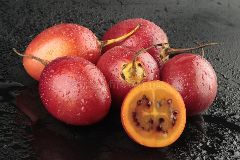 Group of tamarillos on black background