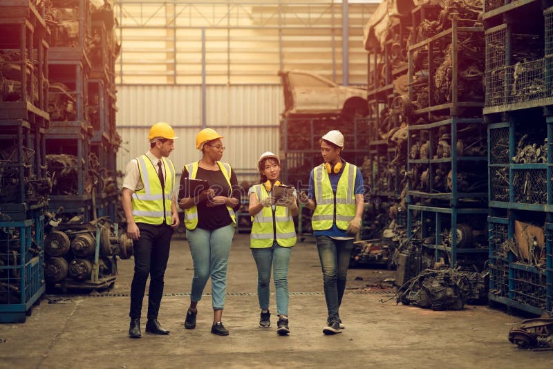 Group of Teamwork Worker mix race enjoy team working in heavy industry factory standing help together smiling happy royalty free stock photography