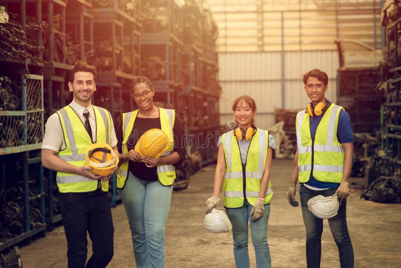 Group of Teamwork Worker mix race enjoy team working in heavy industry factory standing help together smiling happy royalty free stock photo