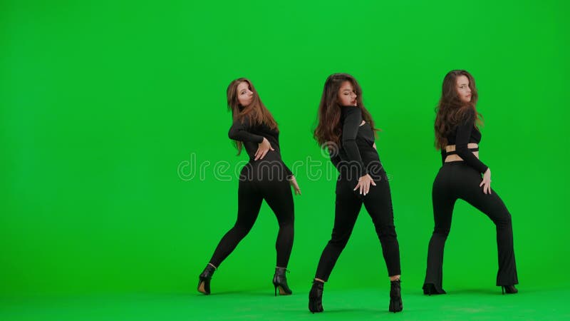 Group of three women dancing heels dance on green screen chroma key background in a studio. Black sexy costume, high