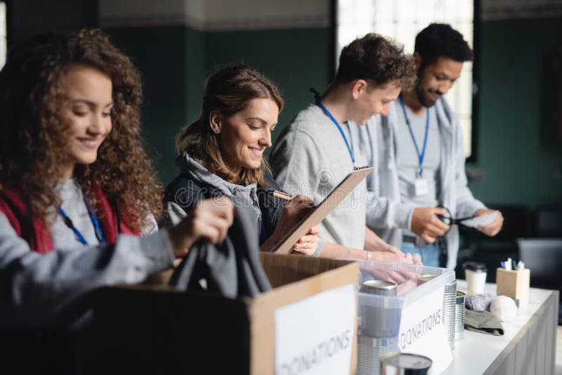 A group of volunteers working in community charity donation center. Charity sorting stock images, royalty-free photos and pictures