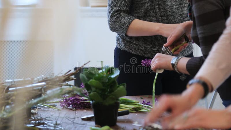 Group of women crafts floral decoration on seminar in art studio.