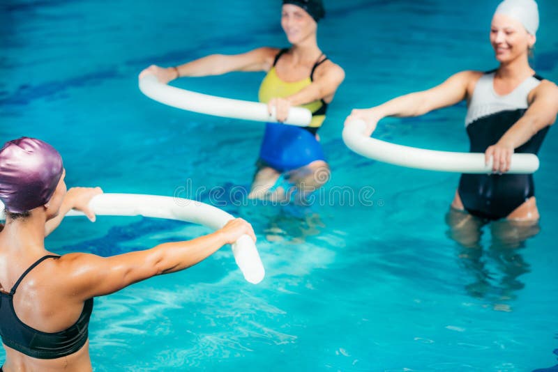 Water Aerobics Class, Group of Women Exercising with Instructor Stock
