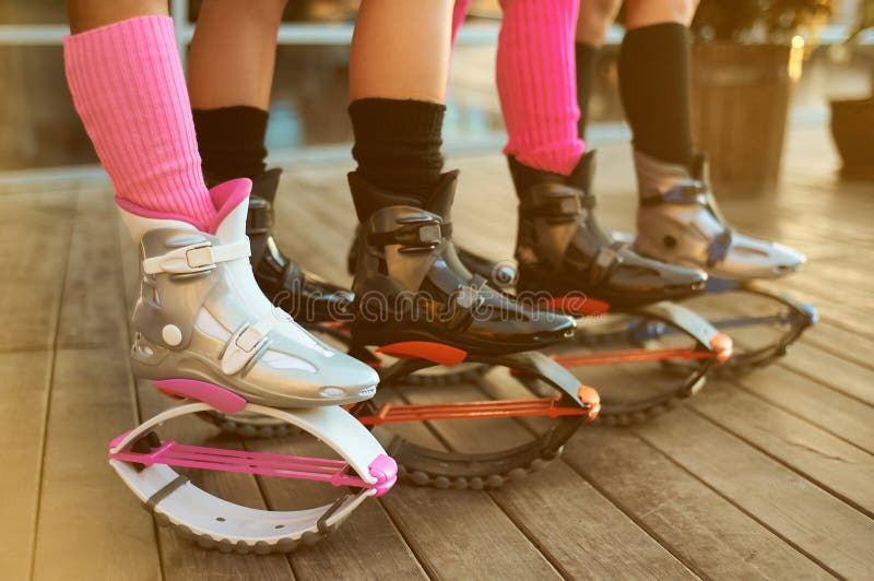 kangoo jumping fitness women team in boots. close up shot with