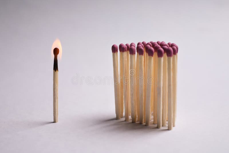 Group of Wooden Matches and Burning One on Light Grey Background Stock