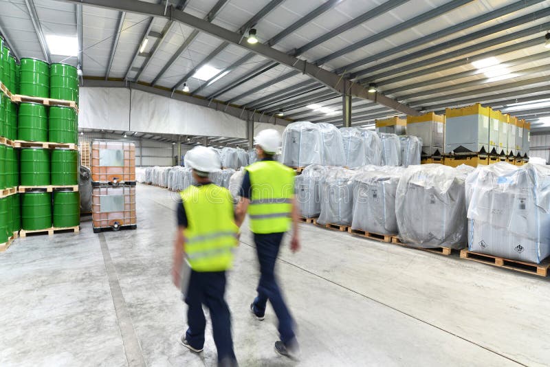 Group of Workers in the Logistics Industry Work in a Warehouse W Stock