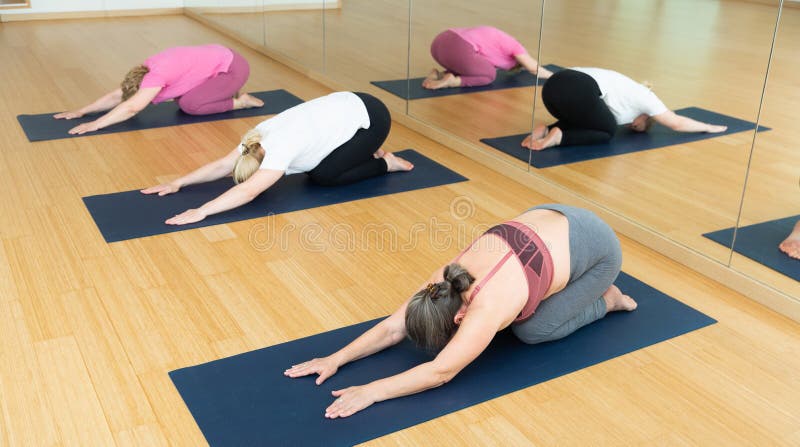 Group Yoga Class - Child Pose Stock Photo - Image of adult, caucasian ...