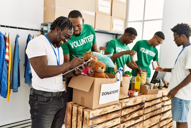 Group of young african american volunteers working at charity center royalty free stock image