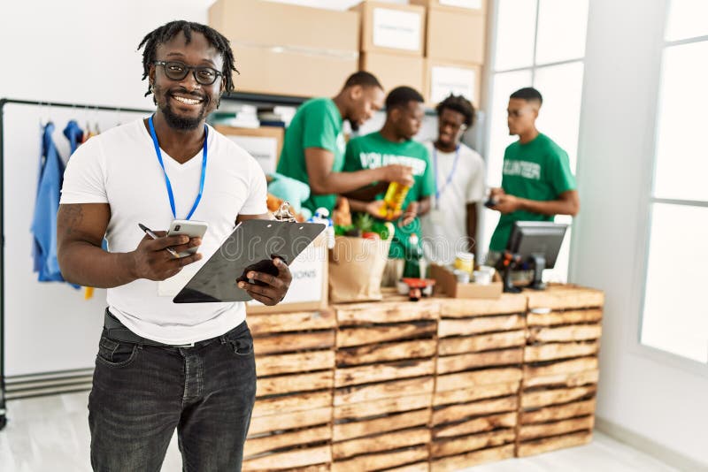Group of young african american volunteers working at charity center stock image