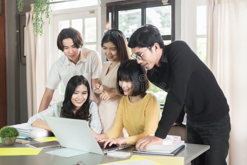 Group of young asian students high school working report together in the library stock photography