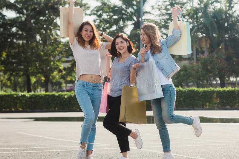 Group of young Asian woman shopping in an outdoor market with shopping bags in their hands. royalty free stock image Group of young Asian woman shopping in an outdoor market with shopping bags in their hands. royalty free stock image