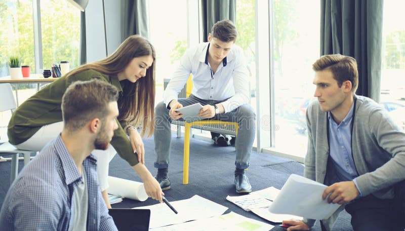 Group of young business people and designers. They working on new project. Startup concept. stock image Group of young business people and designers. They working on new project. Startup concept. stock image