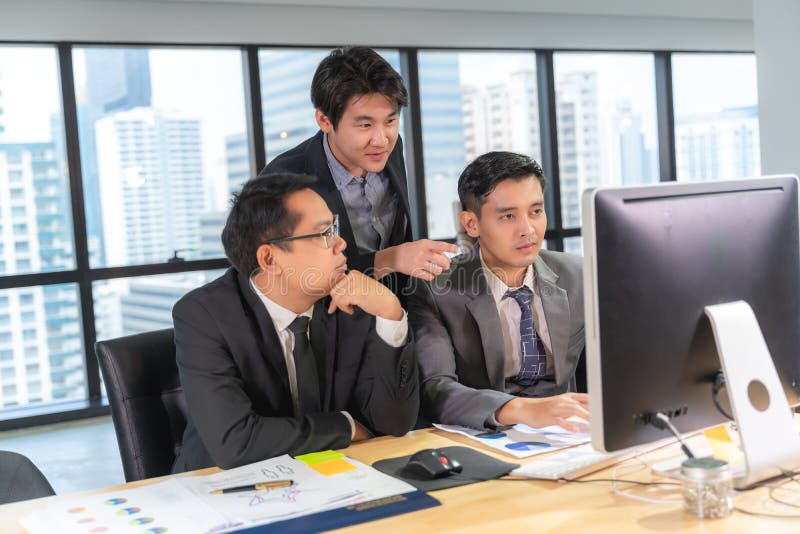 Group of Young Business People Working and Communicating while Sitting