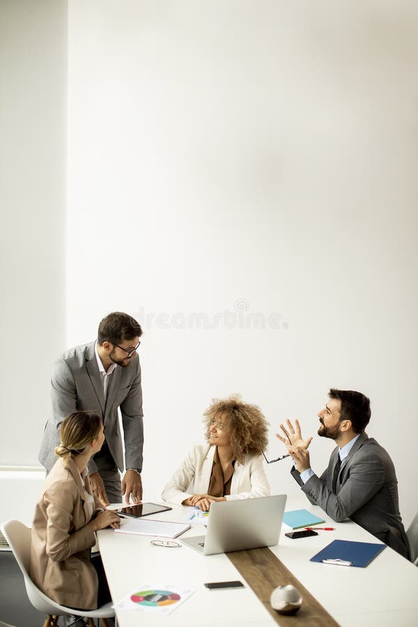 Group Of Young Business People Working And Communicating While Sitting