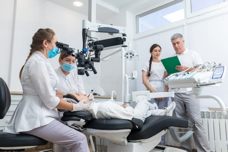Group of Young Doctors Learning in Dental Clinic Watching Dental