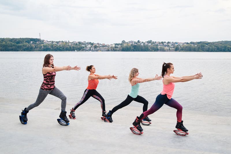 A Group of Young Fit Slim Women in Kangoo Jumps, Training in Front of City  Lake in Summer. Four Girls, Wearing Colorful Sports Stock Photo - Image of  jumps, jumpers: 184326964