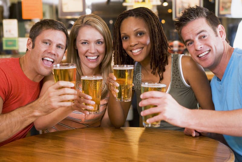 Group of Young Friends in Bar Toasting the Camera Stock Image Image