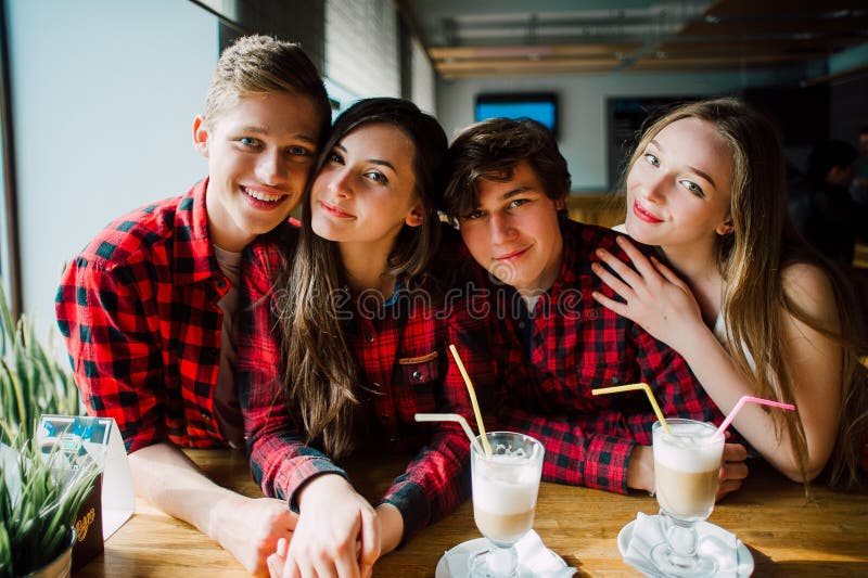 Group of young friends hanging out at a coffee shop. Young men and women meeting in a cafe having fun and drinking coffee. Lifesty stock images Group of young friends hanging out at a coffee shop. Young men and women meeting in a cafe having fun and drinking coffee. Lifesty stock images