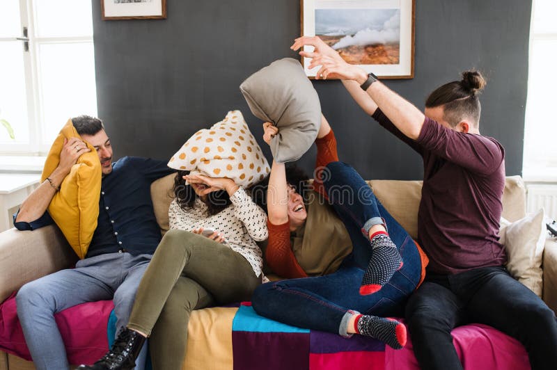 A group of young friends indoors at home, having fun. House sharing concept. royalty free stock photos A group of young friends indoors at home, having fun. House sharing concept. royalty free stock photos