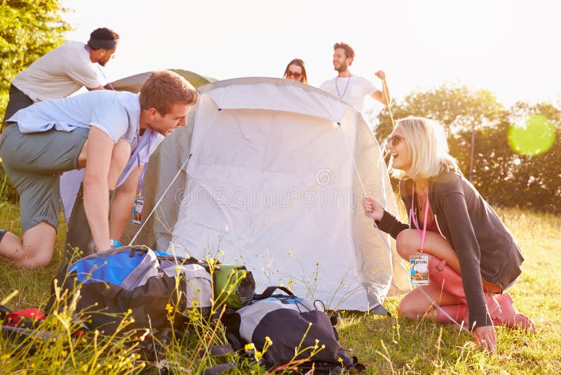 Group of Friends Relaxing Outside Tents on Camping Holiday Stock Photo