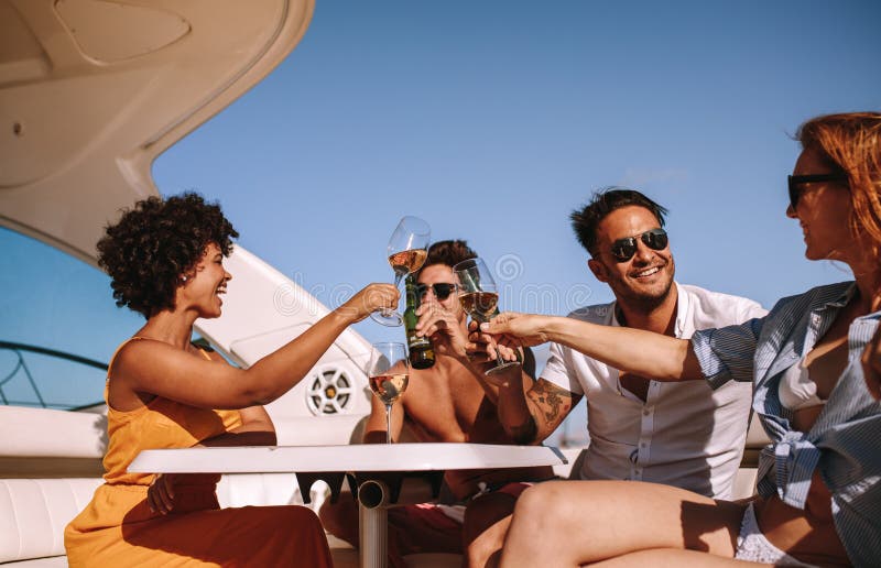 Friends partying on a boat with drinks