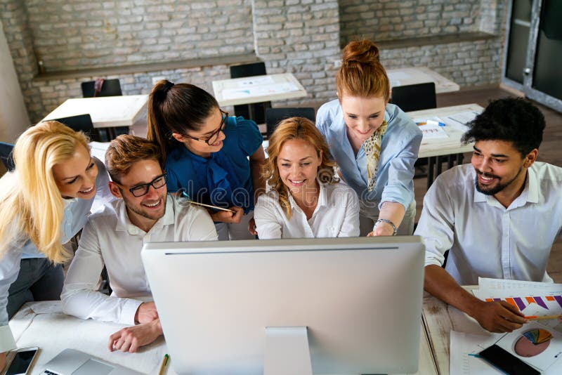 Group of young multi ethnic startup business team collaborating on project in modern office successful start up entrepreneurs imagens de stock