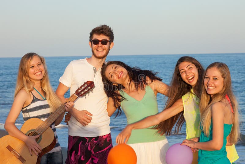 Large Group Of Young People Enjoying A Beach Party Stock Photo, Picture and  Royalty Free Image. Image 21131228.