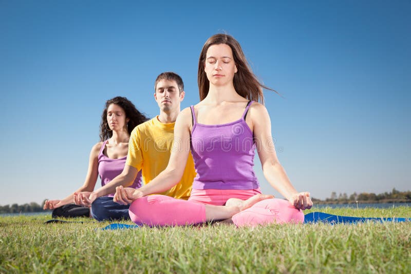 Group of young people have meditation on yoga class.