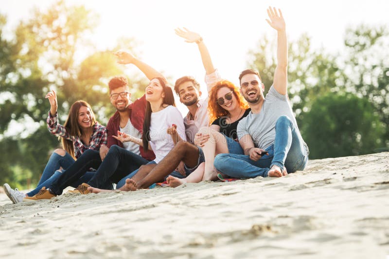 Group of young people having fun outdoors on the beach stock photos