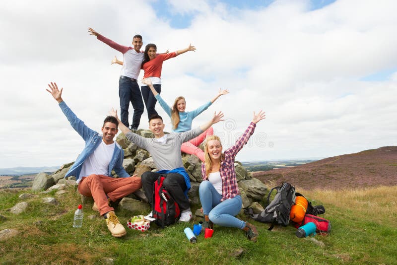 Group Of Young People Hiking In Countryside