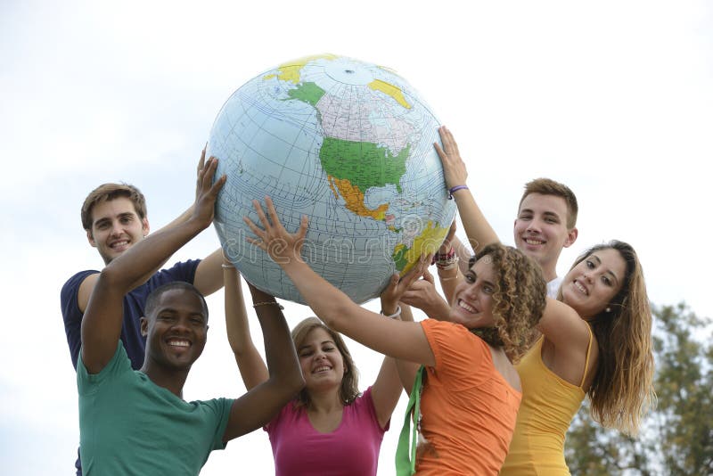 Group of young people holding a globe earth