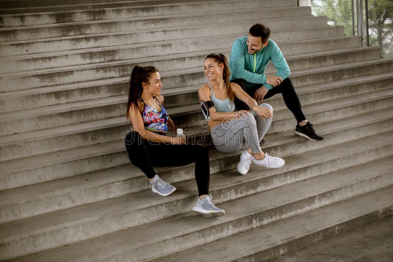 Young people resting during training with bottle of water royalty free stock photos