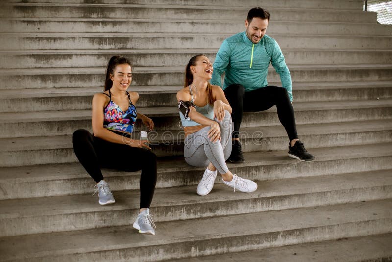 Young people resting during training with bottle of water stock photography
