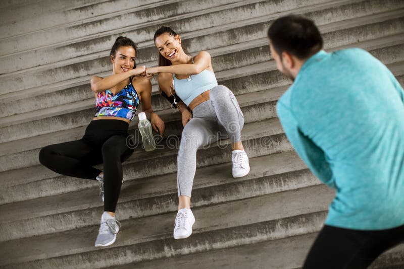 Young people resting during training with bottle of water stock photo